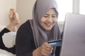 Muslim Woman Making Online Purchase Royalty Free Stock Photo