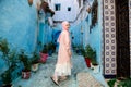 Tourist on a blue street in Chefchaouen, Morocco Royalty Free Stock Photo