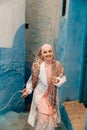 Tourist on a blue street in Chefchaouen, Morocco Royalty Free Stock Photo