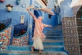 Tourist on a blue street in Chefchaouen, Morocco Royalty Free Stock Photo