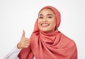 Muslim woman, portrait and thumbs up with hijab in thank you, success or winning against a studio background. Happy