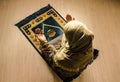 Muslim woman praying for Allah muslim god at room near window. Hands of muslim woman on the carpet praying in traditional wearing Royalty Free Stock Photo