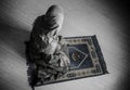 Muslim woman praying for Allah muslim god at room near window. Hands of muslim woman on the carpet praying in traditional wearing Royalty Free Stock Photo