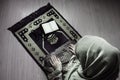 Muslim woman praying for Allah muslim god at room near window. Hands of muslim woman on the carpet praying in traditional wearing Royalty Free Stock Photo