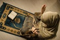 Muslim woman praying for Allah muslim god at room near window. Hands of muslim woman on the carpet praying in traditional wearing Royalty Free Stock Photo