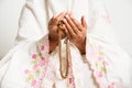 Muslim woman praying close up image of hands as she holds prayer beads,tasbih Royalty Free Stock Photo