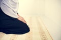 Muslim woman praying in room