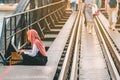 Muslim woman relax and admire the beautiful scenery in the evening on The Bridge of the River Kwai