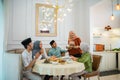 muslim woman serving drink for friend and family after fasting Royalty Free Stock Photo