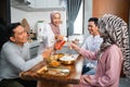 muslim woman serving drink for friend and family after fasting Royalty Free Stock Photo