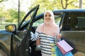 Muslim woman with shopping bags near her car Royalty Free Stock Photo