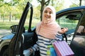 Muslim woman with shopping bags near her car Royalty Free Stock Photo