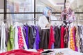 Muslim woman sorting her clothes in her own store