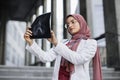 Muslim woman surgeon, looking at X-Ray radiography of patient& x27;s head skull