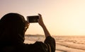 Muslim woman taking a photo on the beach Royalty Free Stock Photo