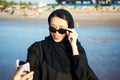 Muslim woman taking selfie on the beach Royalty Free Stock Photo