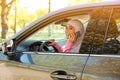 Muslim woman talking on phone in driver`s seat Royalty Free Stock Photo