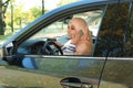 Muslim woman talking on phone in driver`s seat Royalty Free Stock Photo