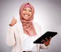 Muslim woman, thumbs up and tablet for success, like and subscribe to human resources website in studio. Portrait of