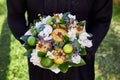 Muslim woman in traditional clothing holding a gift in the form of a bouquet of flowers and fruits Royalty Free Stock Photo