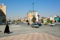 Muslim woman in traditional hijab dress rushing on the busy city street with many cars Royalty Free Stock Photo