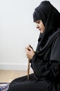 Muslim women using misbaha to keep track of counting in tasbih Royalty Free Stock Photo