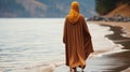 A Muslim woman in a veil or veil walks along the beach near the ocean. Royalty Free Stock Photo