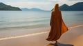 A Muslim woman in a veil or veil walks along the beach near the ocean. Royalty Free Stock Photo