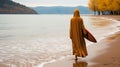 A Muslim woman in a veil or veil walks along the beach near the ocean. Royalty Free Stock Photo