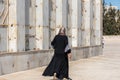 Muslim woman walking at the square of the Golden Dome of the Rock, Qubbat al-Sakhra, an Islamic shrine located on the Temple Mount