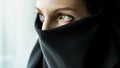 Muslim woman wearing burkha and looking out