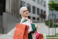 Muslim woman, wearing casual clothes, going for shopping in background of modern city buildings. Royalty Free Stock Photo