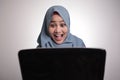 Muslim Woman Working on Laptop Shocked Stunned Excited Gesture Royalty Free Stock Photo