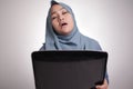 Muslim Woman Working on Laptop, Tired Sleepy Expression, Exhausted Overworked Concept Royalty Free Stock Photo