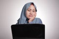 Muslim Woman Working on Laptop, Tired Sleepy Expression, Exhausted Overworked Concept Royalty Free Stock Photo