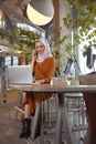 Muslim Woman. Young Girl In Hijab Portrait. Beautiful Female Sitting In Cafe And Working On Laptop. Royalty Free Stock Photo