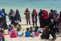 Muslim women and children having fun at the beach