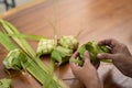 Women make traditional ketupat food for Eid celebrations at home