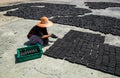 Muslim women put charcoal pack bar made from coconut shell on the floor dry in the sun Royalty Free Stock Photo