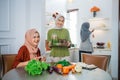 muslim woman serving drink for friend and family after fasting Royalty Free Stock Photo