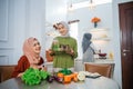 muslim woman serving drink for friend and family after fasting Royalty Free Stock Photo