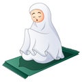 Muslim women sitting on the prayer rug while praying