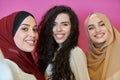 Muslim women taking selfie by mobile phone isolated on pink background Royalty Free Stock Photo