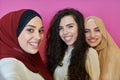 Muslim women taking selfie by mobile phone  on pink background Royalty Free Stock Photo