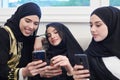 Muslim women using mobile phone at home Royalty Free Stock Photo