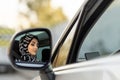 Muslim young woman is driving car carelessly