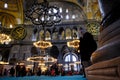 Muslims praying and tourist walking inside the mosque covered bottom of mosque with turquoise carpet Royalty Free Stock Photo