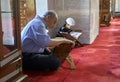 Muslims read the Holy Quran at the mosque. Royalty Free Stock Photo