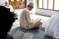 Muslims reading from the Quran