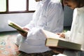 Muslims reading from the Quran